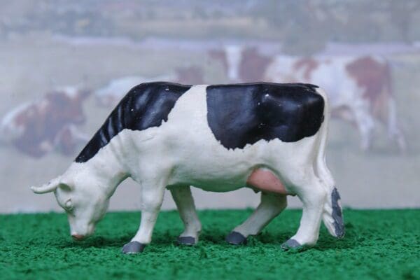 SOLD Timpo Black-and-White Feeding Cow - Near MINT!