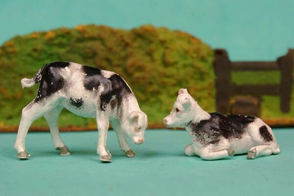 SOLD Black Stencil-sprayed Calves Feeding & Lying